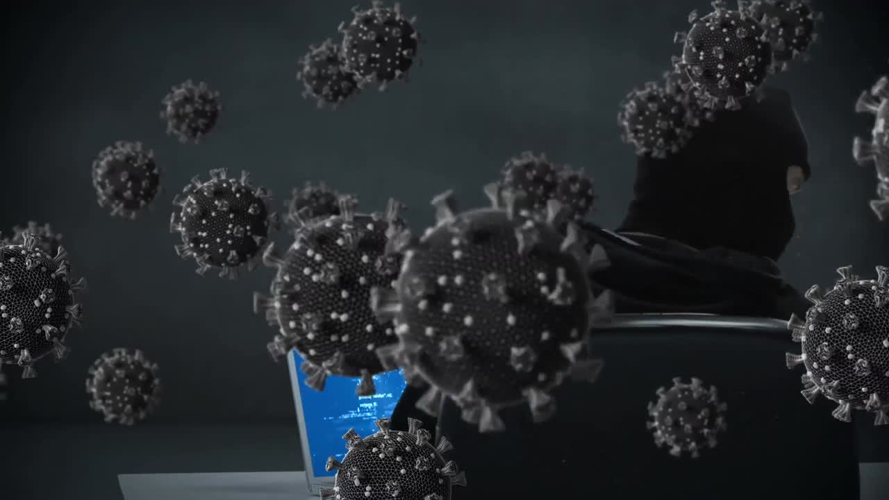 노트북을 사용하여 발라클라바를 입은 남성에 대한 거대한 코로나19 세포의 애니메이션