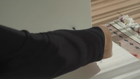 person assembling furniture with a screwdriver