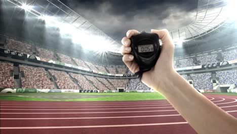 Hand-holding-stopwatch-in-olympic-stadium