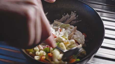 Mixing Fileja Pasta In A Bowl With Chopped Bell Pepper, Mayonnaise, And Seasonings