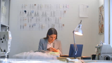 handmade decorate the dress with crystals. seamstress creates an exclusive dress.