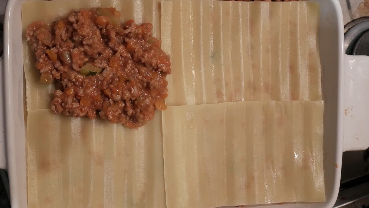 Uncooked lasagna sheets in a baking dish, ready for assembling layers