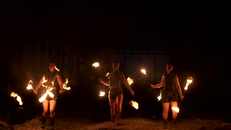 Slow-motion:-Fire-show-in-the-hangar-show-three-female-artist-and-a-man-with-flamethrowers