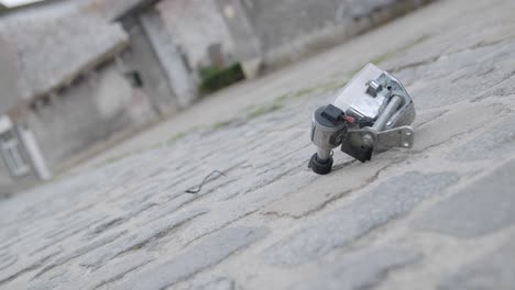 bicycle driving on a cobblestone road, losing its dynamo