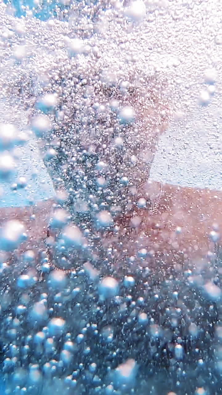 Man swimming in pool. Handsome man swimming underwater in pool