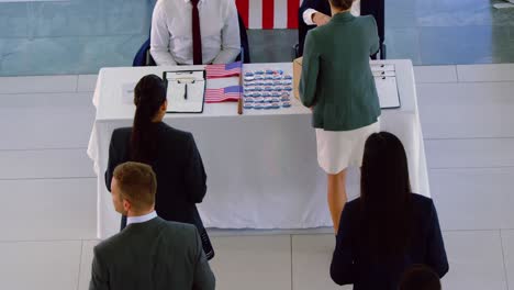 business people checking in at conference registration table 4k