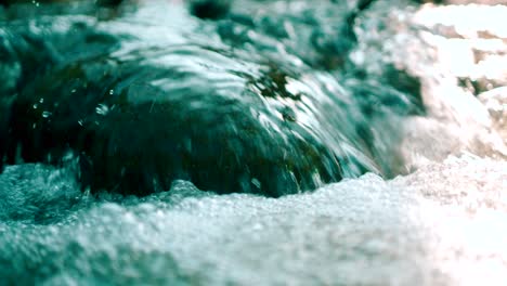 close shot of flowing water in a mountain stream