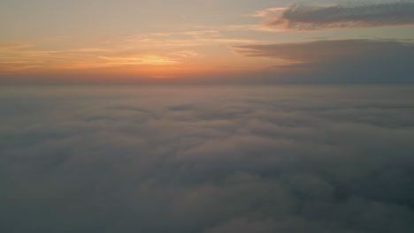 amazing sunrise fluffy clouds aerial view. golden horizon at summer morning