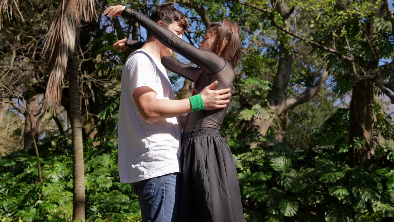 Couple Hugging and Kissing in a Park