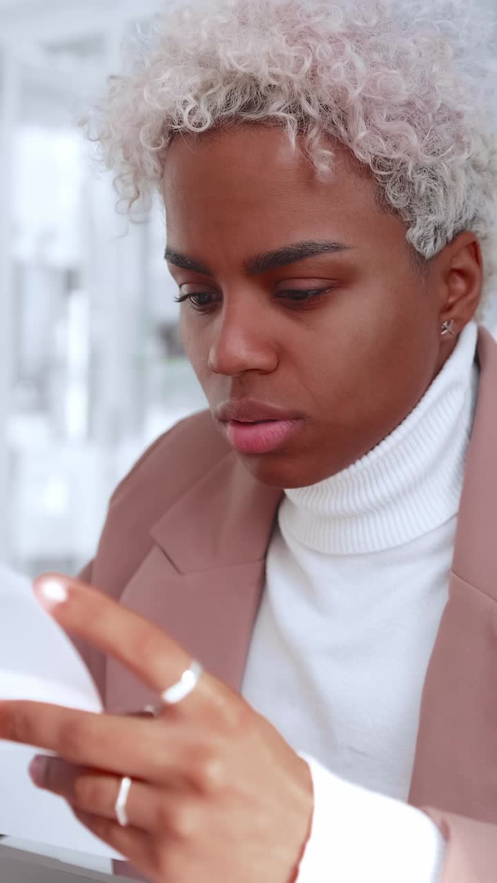 Young woman checking documents while working at a desk in an office