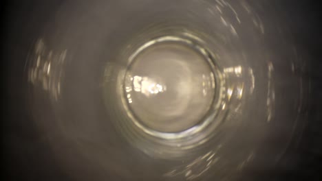 Moving-out-of-a-clear-glass-vase-near-the-left-edge,-using-a-wide-angle-probe-lens