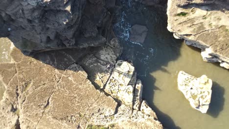bird's eye shot of subject with gradual rise to reveal cliffs and coastline of south shields, england