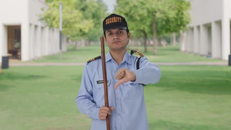 disappointed indian security guard showing thumbs down