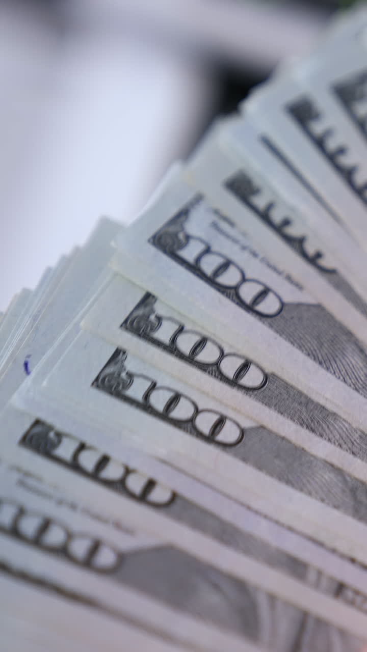 Female hands counting us dollars. Woman hand count the united states currency. A bunch of american Banknotes. Vertical video