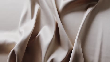 Close-up-of-white-shiny-silk-cloth-in-slow-motion