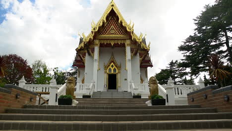 zoom in, walking towards a small and hidden buddhist thai temple