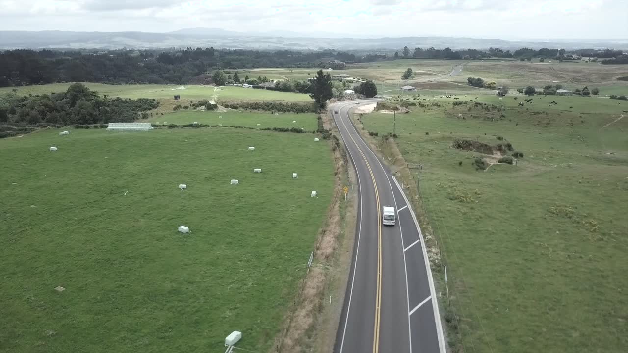 Aerial view of road through green field