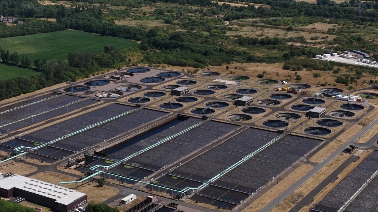 Aerial view of a wastewater treatment plant with settling tanks, filtration and biological processing used to clean sewage and safely discharge or reuse treated water.