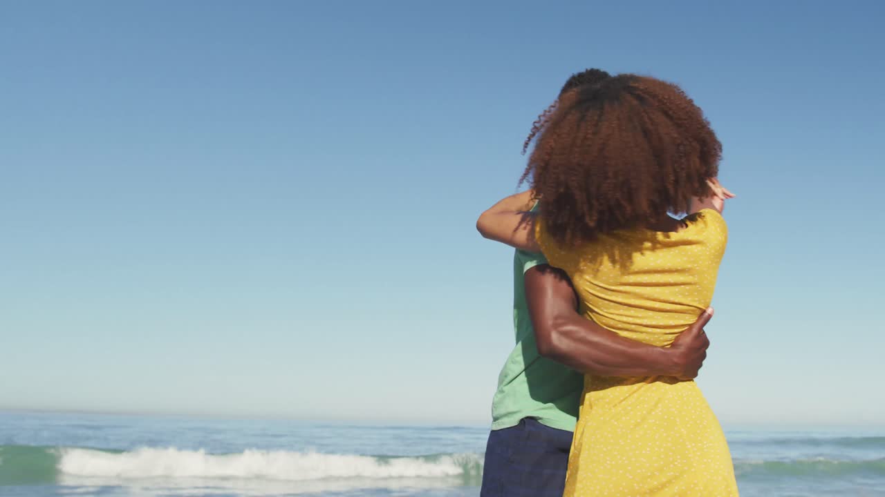 African American couple dancing seaside