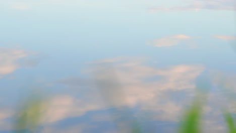 slow cinematic pan across beautiful cloud and sky reflections in water