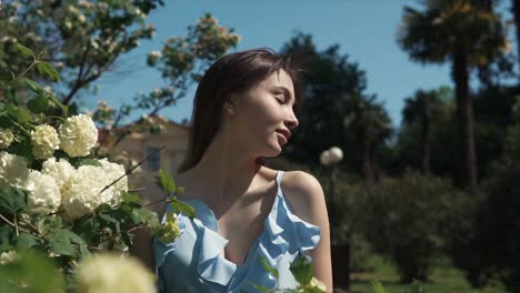 woman in a blue dress in a park