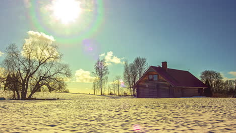 The-sun-gracefully-dances-across-the-winter-sky,-creating-a-mesmerizing-rainbow-as-the-picturesque-scene-unfolds-in-a-breathtaking-time-lapse,-while-the-clouds-elegantly-drift-by