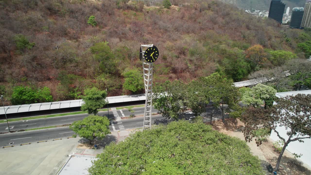 Aerial drone view circling iconic clock tower at Universidad Central de Venezuela