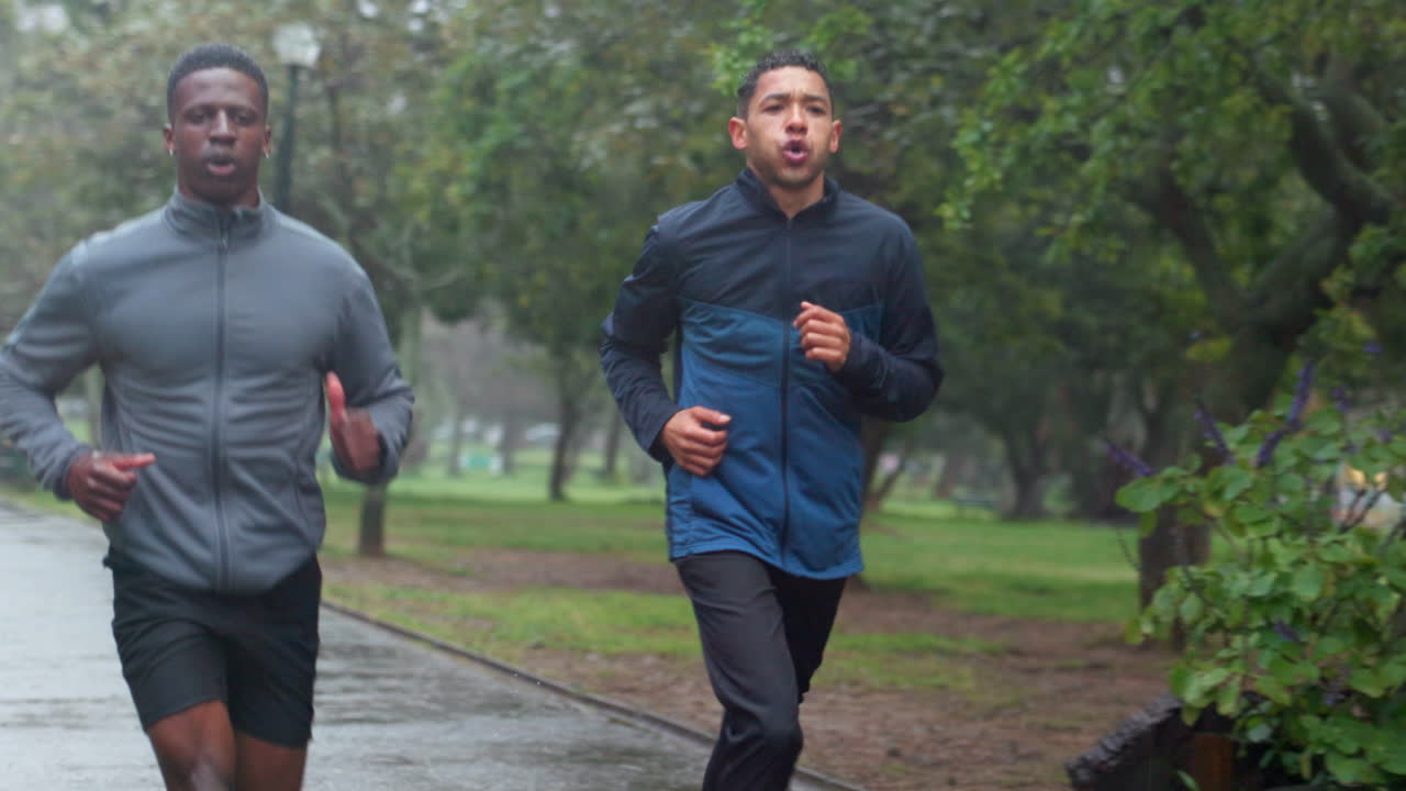 Two men jogging in the rain
