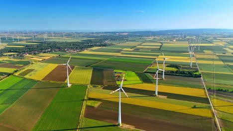 wind turbines in clear fields. wind turbines stand tall in vibrant green and yellow fields, showcasing renewable energy in a sunny landscape