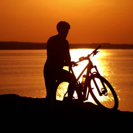 rider resting on cycling trip in nature