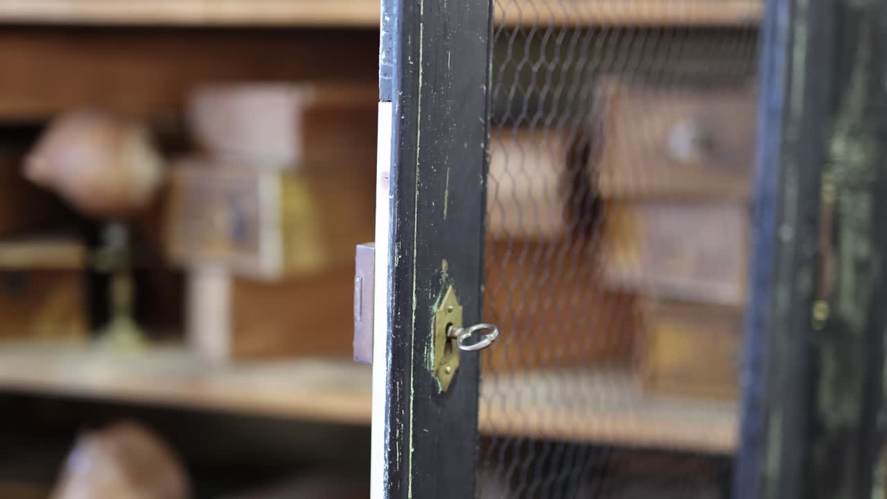 baratijas antiguas y cajas de almacenamiento de madera en los estantes de un armario de madera