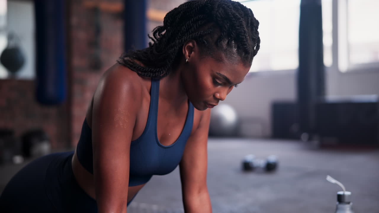 Woman doing a plank exercise in a gym