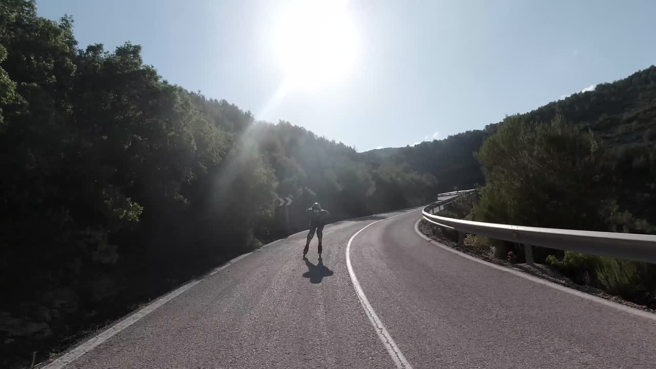 Downhill roller skating front facing follow shot