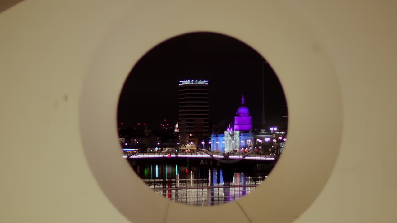 Liberty Hall and The Custom House lit by winter projections, framed by Samuel Beckett Bridge design