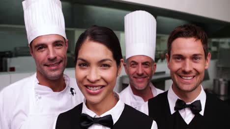 cheerful restaurant staff smiling at camera