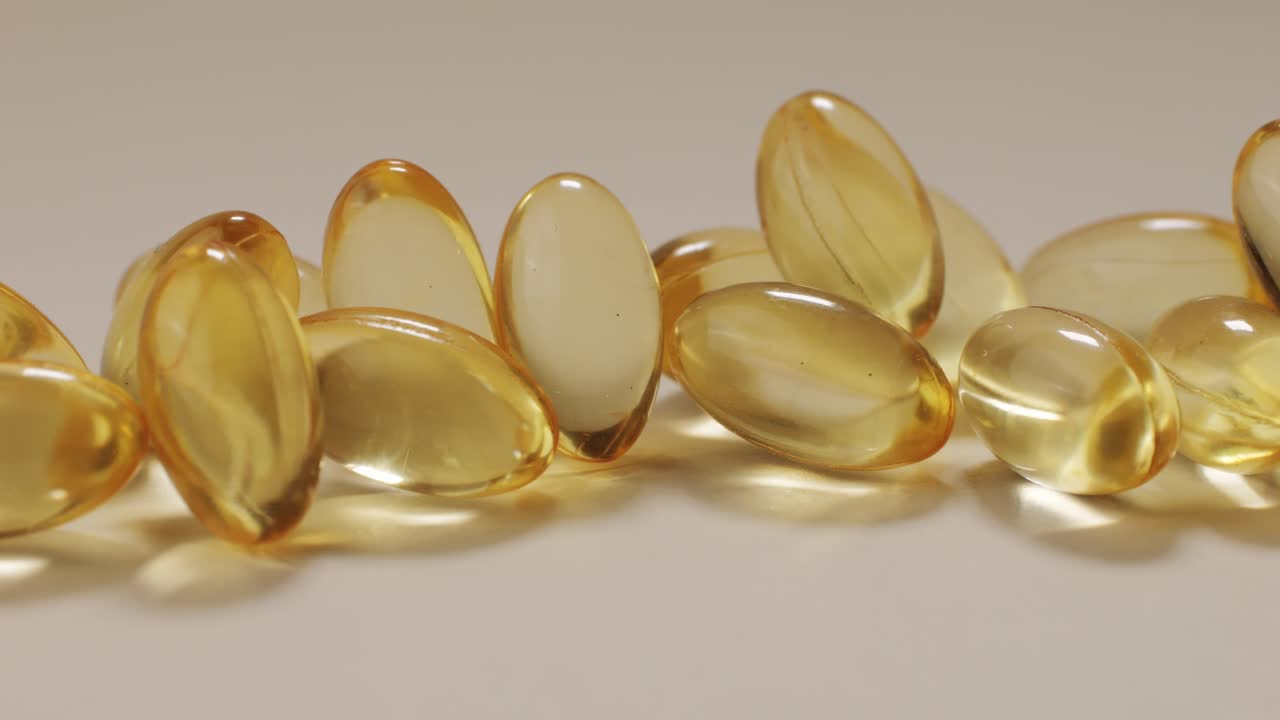 Omega fish oil gel capsules on black background close-up . Omega vitamins pills 3 6 9. To be healthy and take care of your health. Pharmaceutical industry. Business of biological supplements and vitamin. High quality 4k footage