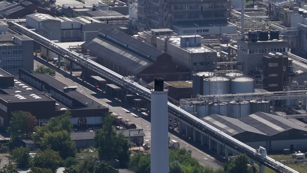 pharmaceutical industrial production site in Pratteln, Switzerland, focusing on industrial area, pharma industry, and manufacturing infrastructure. Aerial video