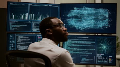 it professional analyzing data on multiple monitors
