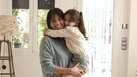 mother and girl embracing and smiling