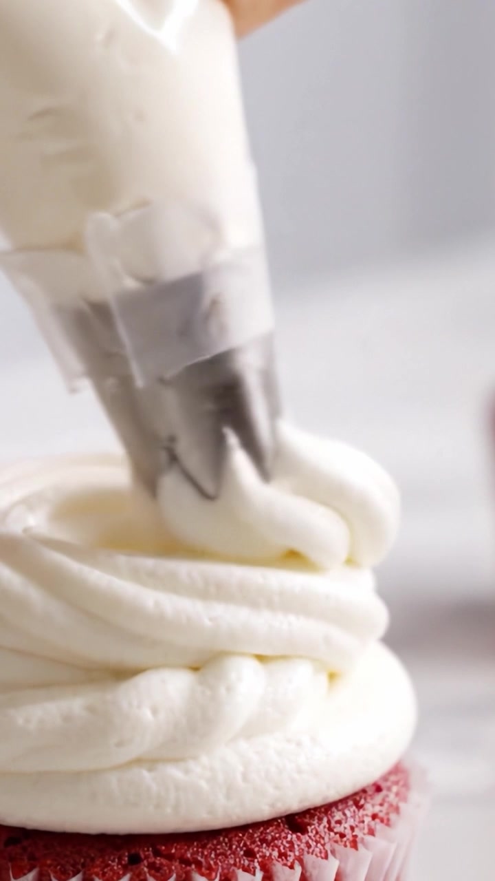 Deliciously Decorated Red Velvet Cupcake with Creamy Frosting Piped to Perfection in an Elegant Fashion, Showcasing the Art of Dessert Decoration and Culinary Delight
