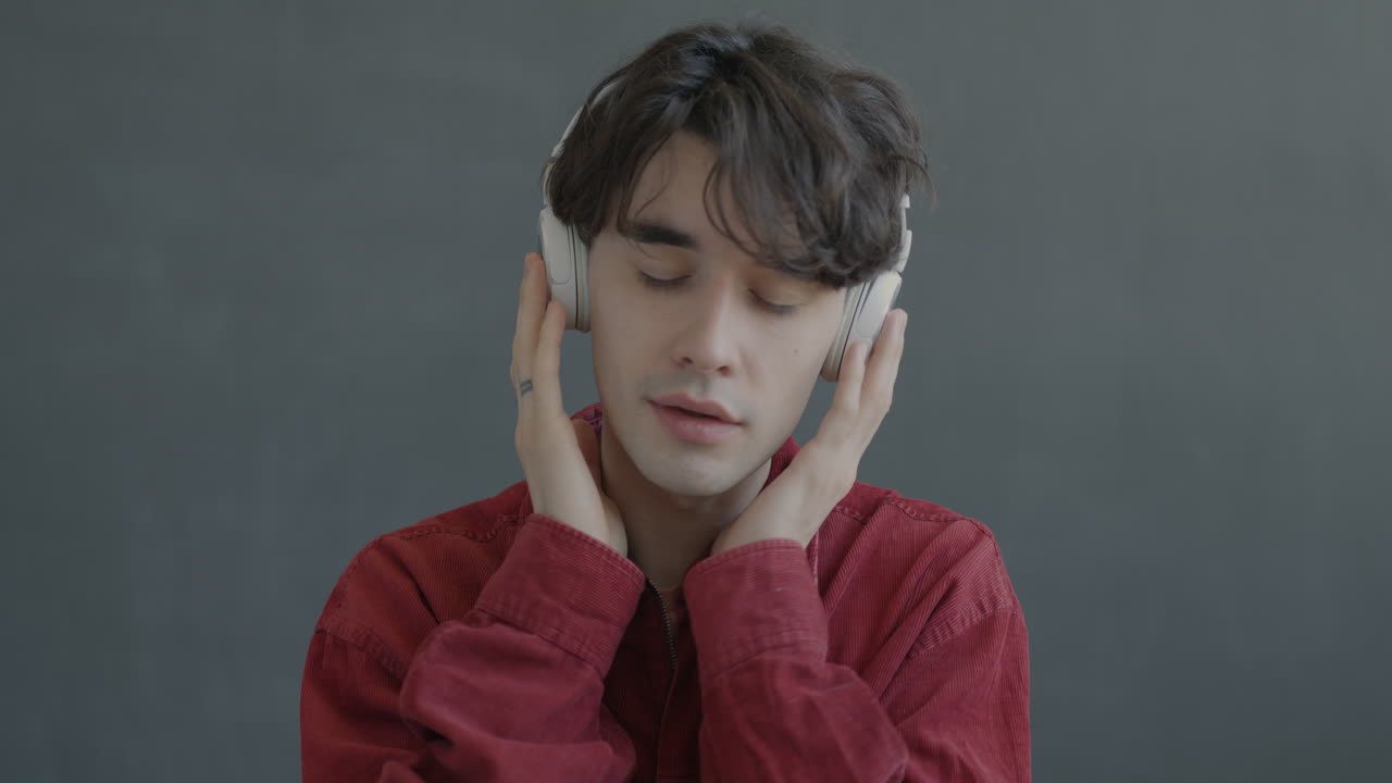 Man Wearing Headphones and Red Jacket