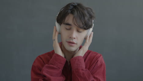 man wearing headphones and red jacket
