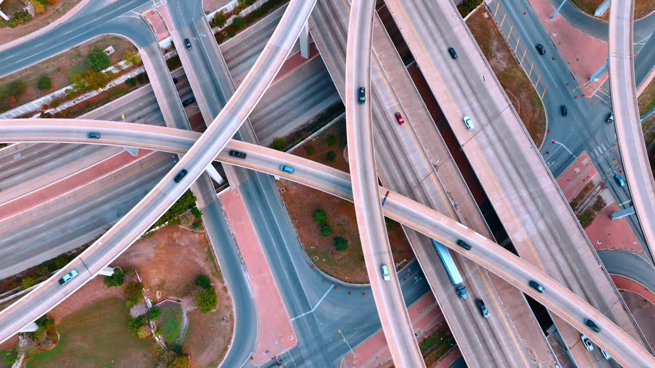 Cars run by the multi-level interchange. Transportation and logistics concept. Top view