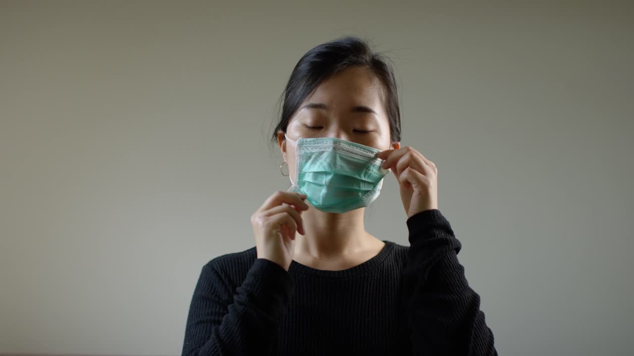 Asian Woman Putting Face On Face Mask in Slow Motion A