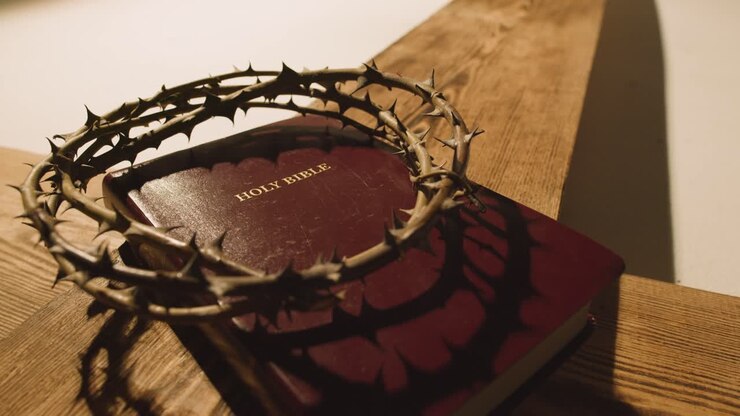 Religious Concept Shot With Crown Of Thorns Bible And Wooden Cross In Pool Of Light