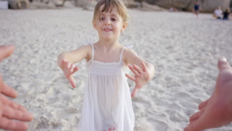 father swinging daughter around on the beach at sunset having fun pov