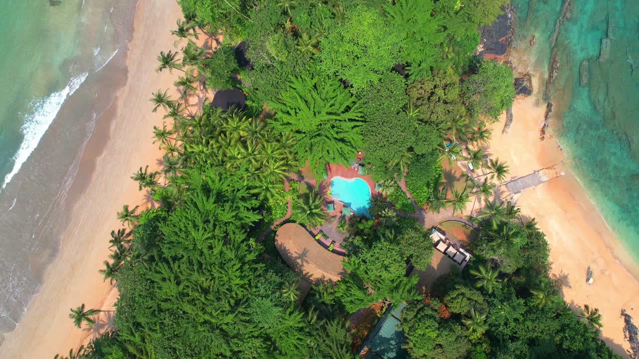 Aerial view descending over the pool at bom bom resort in the middle of two beaches with the same name at Ilha do Principe (Prince Island) Sao Tome,Africa