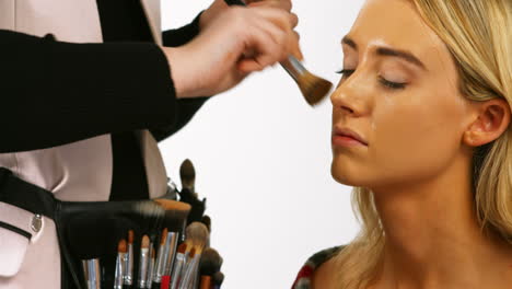 make up artist applying make up