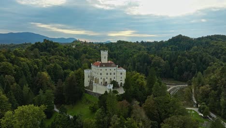 trakoscan castle surrounded by lush vegetation in croatia - aerial drone shot