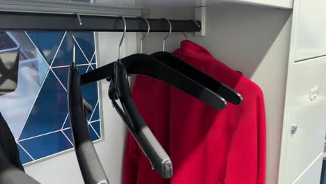 coat hangers move in an almost empty wardrobe